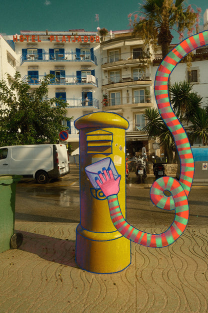 Yellow Correos mailbox in Sitges, Spain with illustration 