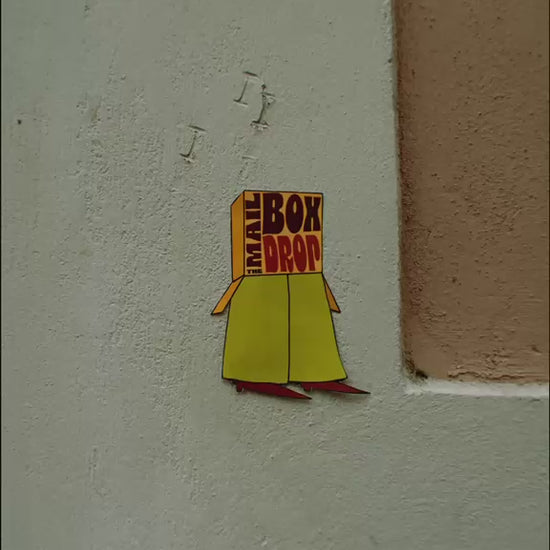The Mailbox Drop logo appearing on colorful textured walls and surfaces around Barcelona.