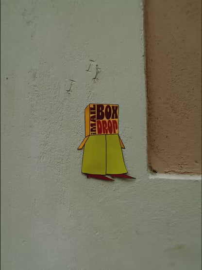 The Mailbox Drop logo appearing on colorful textured walls and surfaces around Barcelona.
